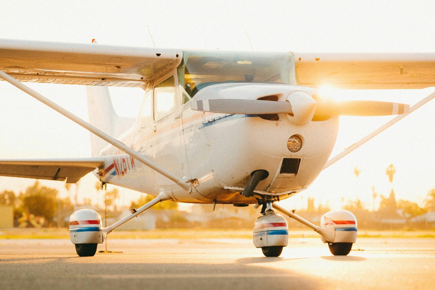 Single-engine Cessna on a ramp at sunset