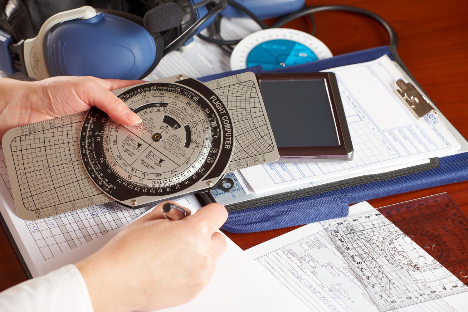 Flight computer and paperwork on a clipboard