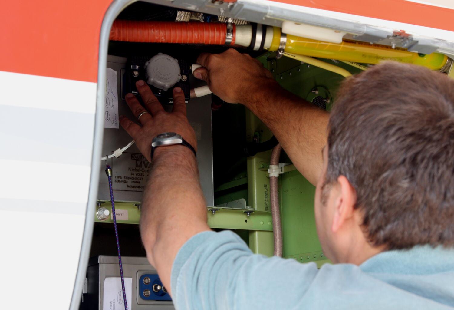 Mechanic working inside an aircraft panel