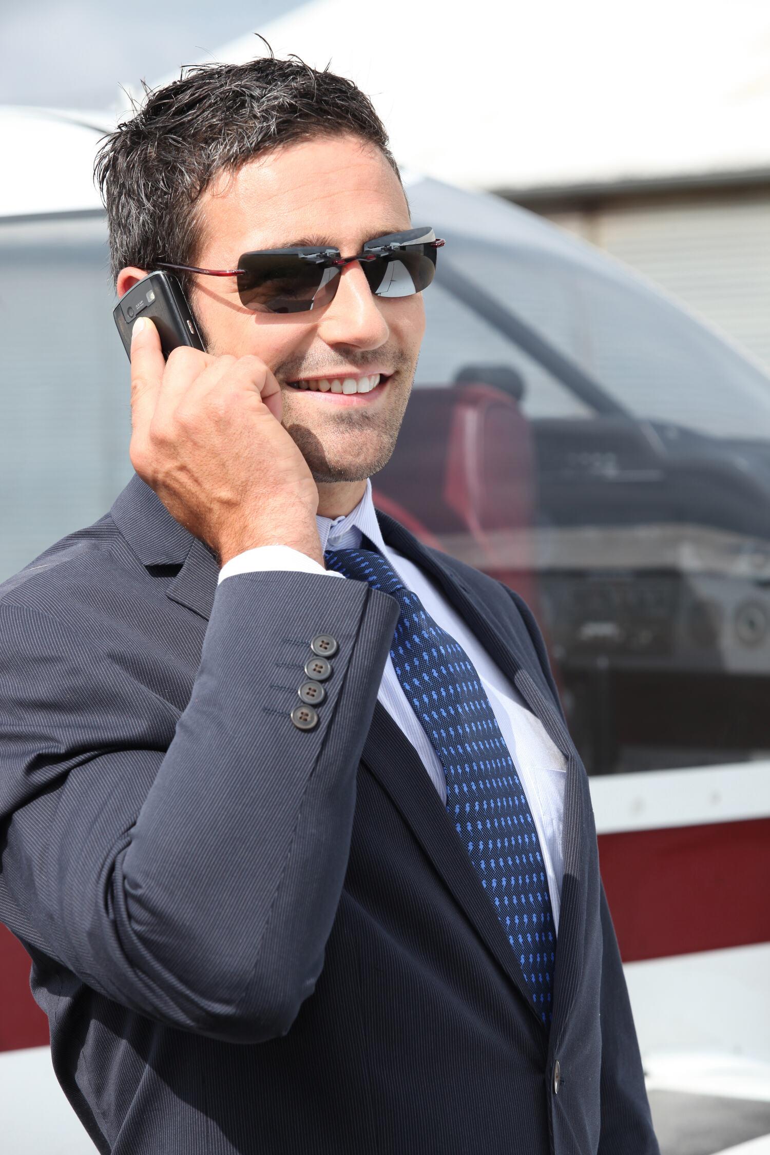 Buyer on the phone beside an airplane