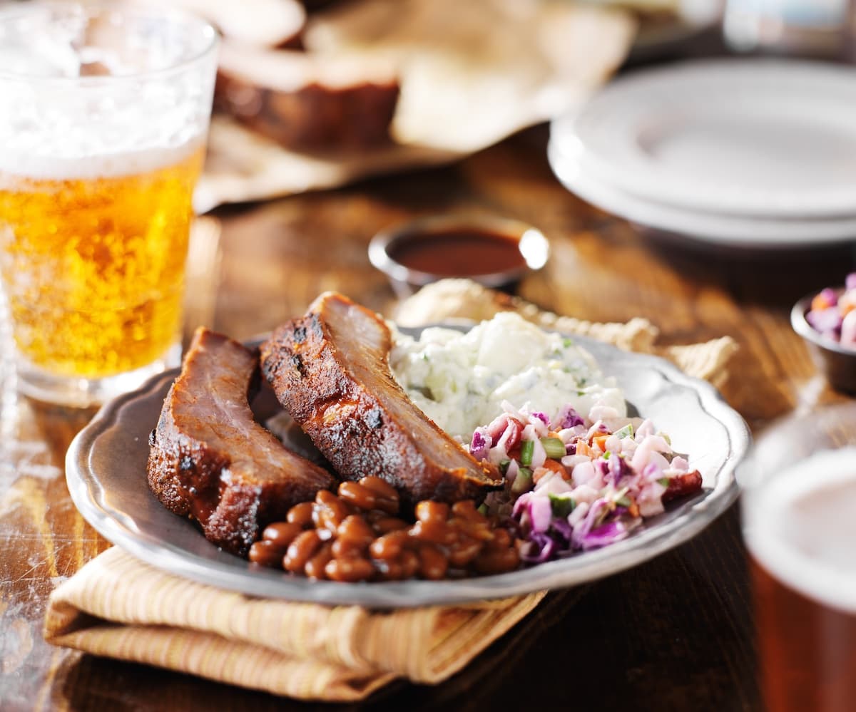 BBQ plate with ribs, beans, and coleslaw